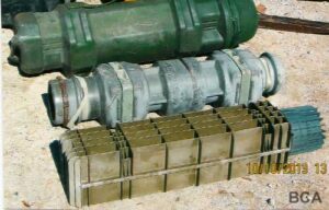 Three miscellaneous green plastic containers for artillery rounds