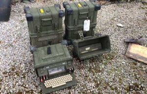 Military communications data terminals in green metal cases