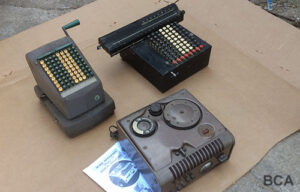 Two vintage mechanical calculators and a 1940s-1950s wire recorder